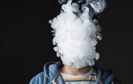 Person blowing out vape smoke