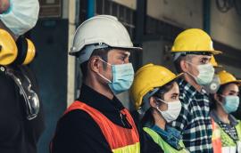Construction workers wear masks.