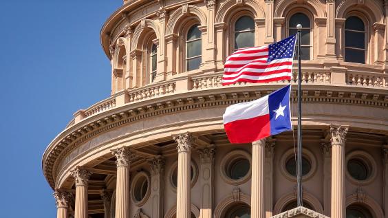 U.S. and Texas flags flying at Texas Capitol Building