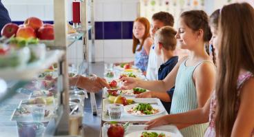  Elementary students at buffet line, enjoying variety of food options