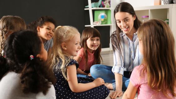 Children with nursery teacher in kindergarten