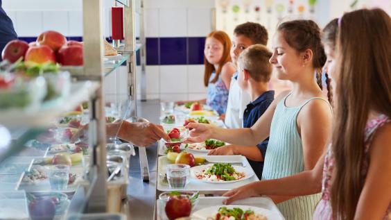  Elementary students at buffet line, enjoying variety of food options