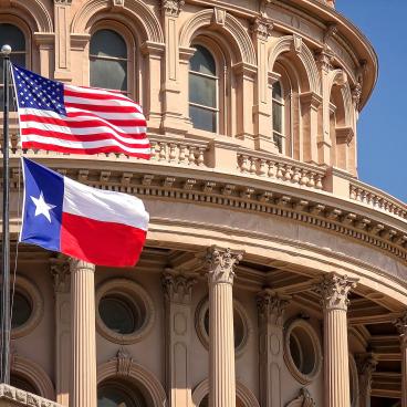 American and Texas state flags and Capitol building