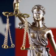 Blind scales of justice with texas flag in background